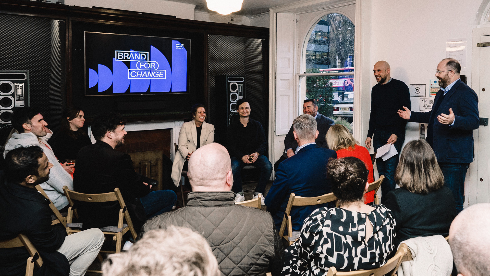 A group of people watching a panel talk on branding