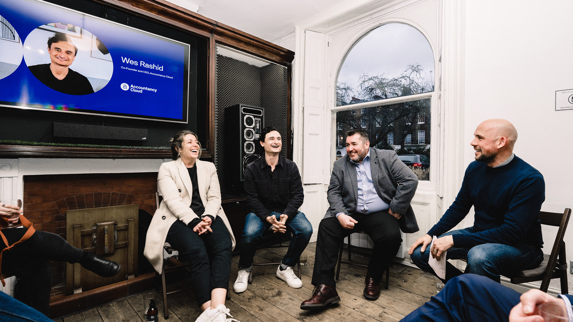 Four people sitting down taking part in a panel discussion