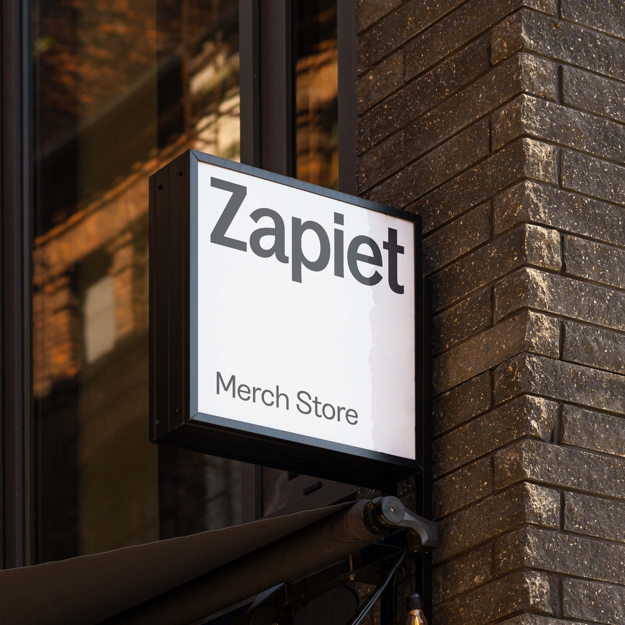 Square store sign attached the corner of a street