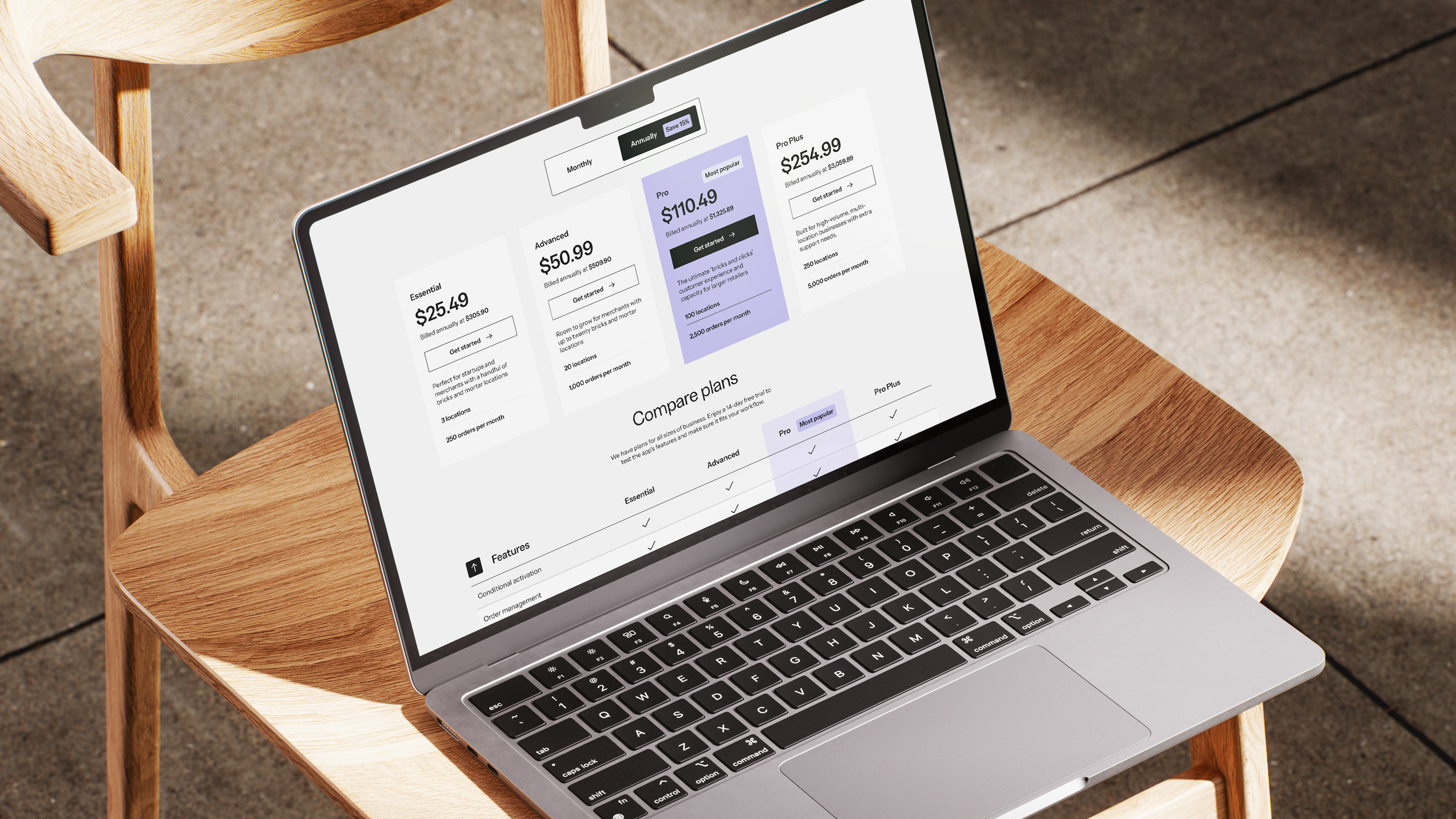 Laptop on a chair displaying pricing table on Zapiet website