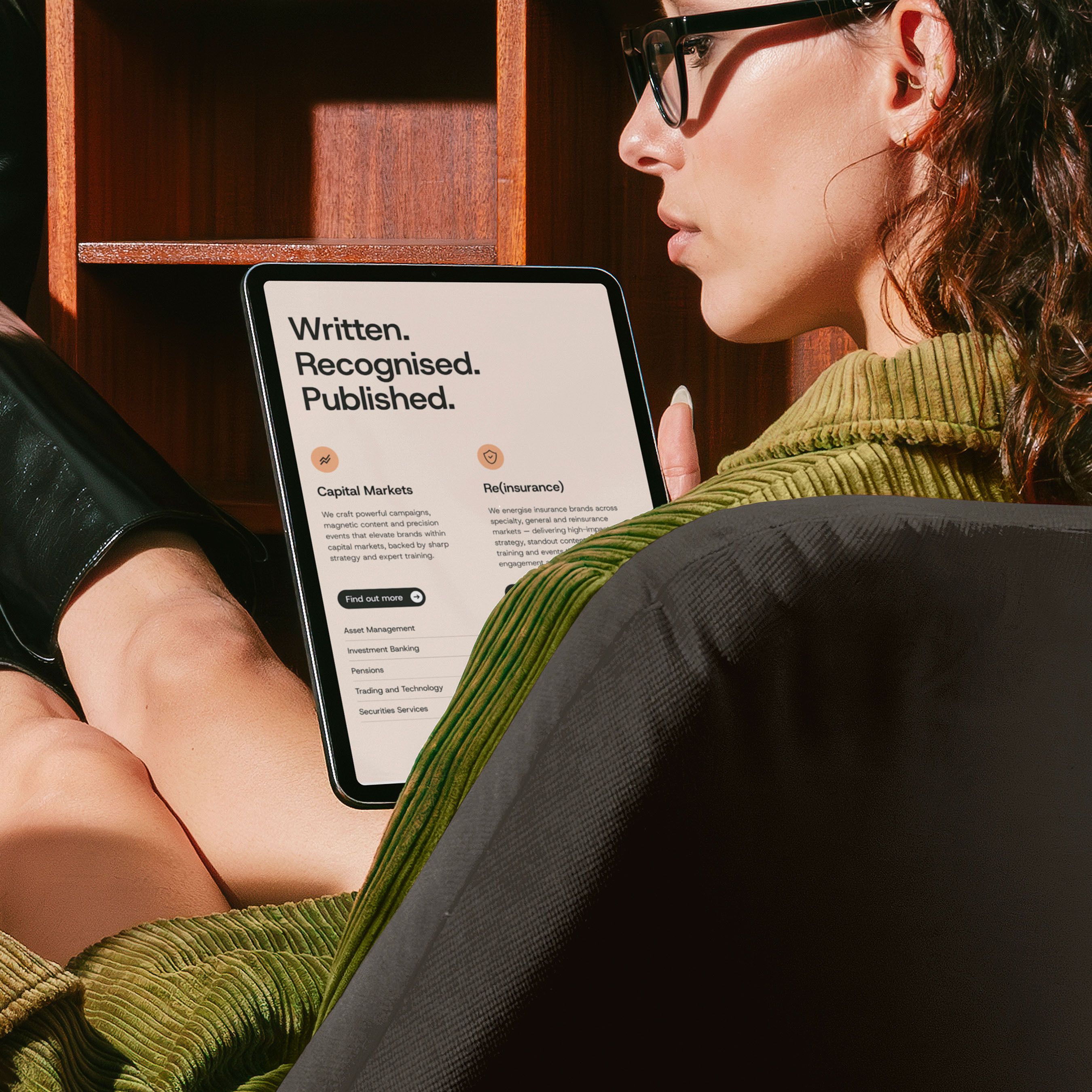 Woman holding iPad showcasing Rhotic website